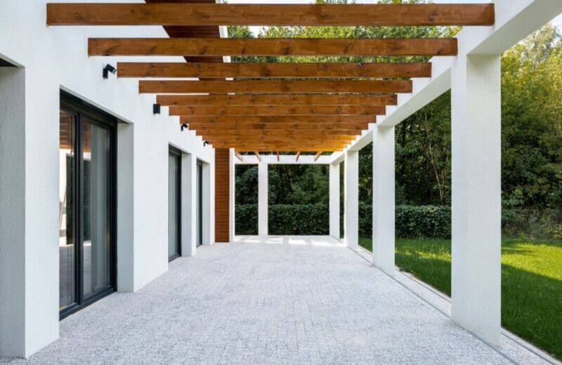 Back patio with gazebo in wood overhead.