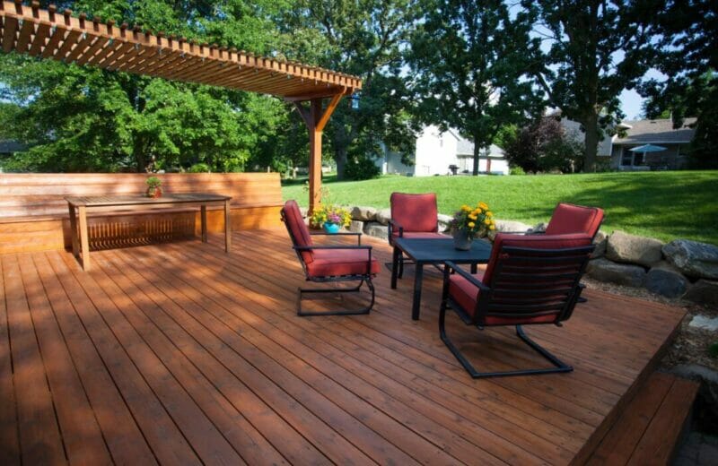 Backyard deck with red and black seating area.