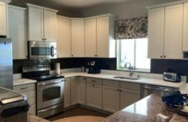 White cabinets with granite counter tops.