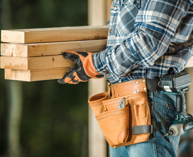 Contractor carrying wood to project ITZ Construction